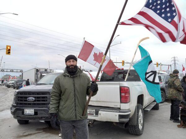 Truck driver Sami Mandalawi takes part in the blockade by the Ambassador Bridge in Windsor, Ontario, on Feb. 10, 2022. (Lisa Lin/The Epoch Times)