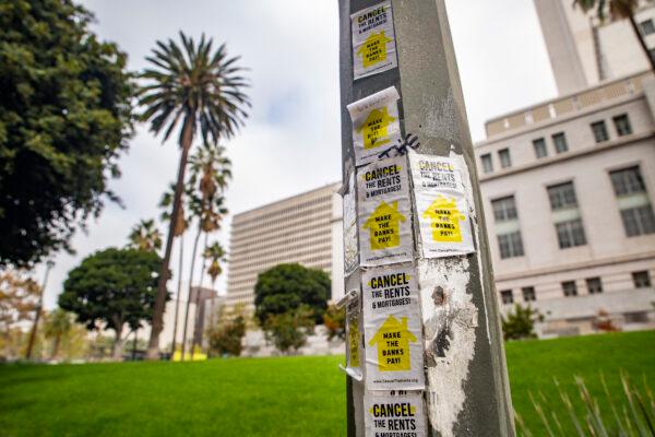 Stickers for rent cancelations are pasted to a light pole in front of Los Angeles City Hall on Nov. 8, 2021. (John Fredricks/The Epoch Times)