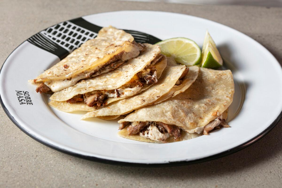 Gringas are a type of taco traditionally made with flour tortillas, al pastor, cheese, and pineapple. At Sobre Mesa, they use corn tortillas made with the extra-starchy cacahuazintle variety, which produces exceptionally soft tortillas. (Melissa Hom)