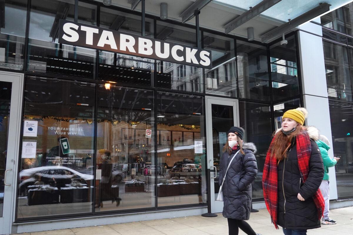 A Starbucks sign hangs above the entrance of one of the chain's coffee shops in the Loop in Chicago, Ill., on Jan. 4, 2022. (Scott Olson/Getty Images)