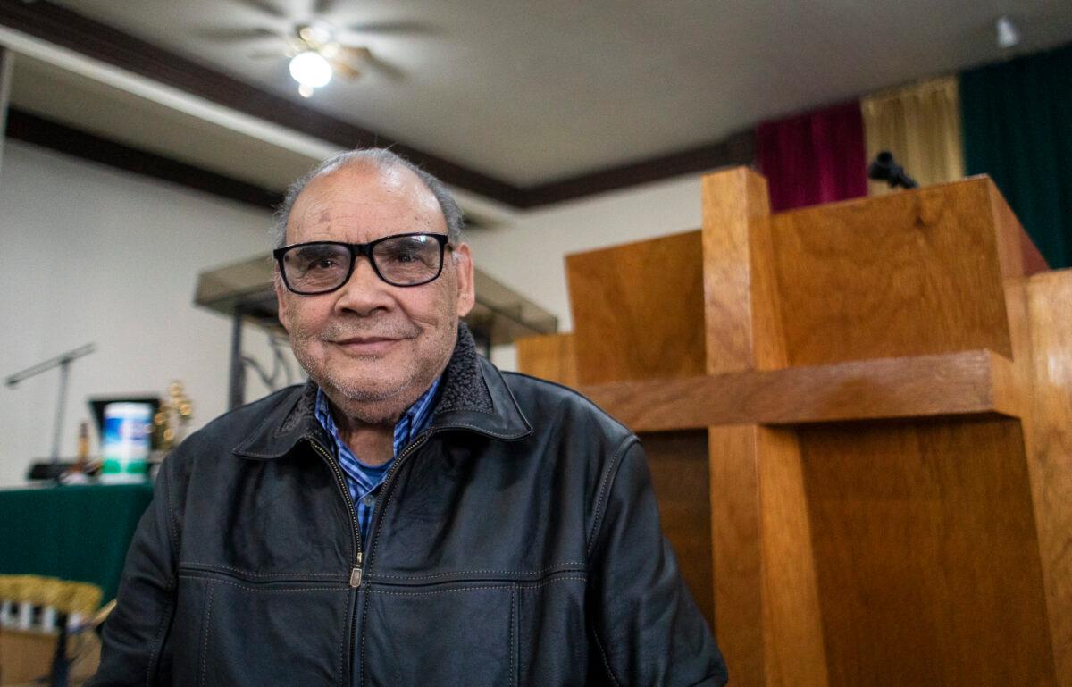Pastor Heriberto Martínez stands at the pew of Iglesia Cristiana Bethel in Tijuana, Mexico, on Feb. 5, 2022. (John Fredricks/The Epoch Times)