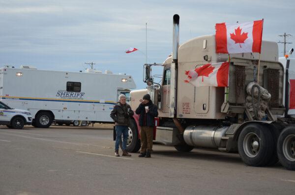 Vehicles parked by Coutts in southern Alberta, Canada, as part of a protest convoy blocking the Canada-U.S. border to demand the removal of COVID-19 mandates, on Feb. 10, 2022. (Michael Wing/The Epoch Times)