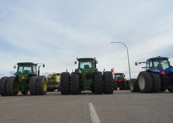 Vehicles parked by Coutts in southern Alberta, Canada, as part of a protest convoy blocking the Canada-U.S. border to demand the removal of COVID-19 mandates, on Feb. 10, 2022. (Michael Wing/The Epoch Times)