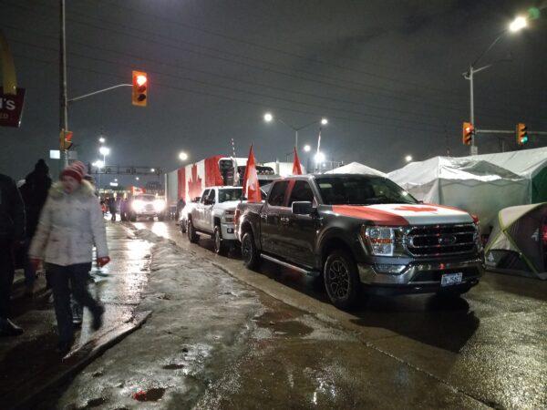 Vehicles parked at the site of a demonstration against COVID-19 mandates and restrictions by the Ambassador Bridge in Windsor, Ont., on Feb. 11, 2022. (Lisa Lin/The Epoch Times)