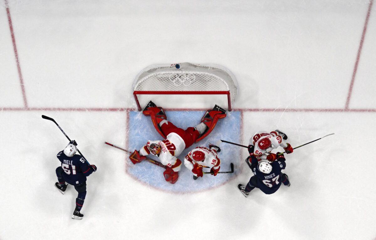 The puck goes into the goal of China during the men's preliminary round group A match of the Beijing 2022 Winter Olympic Games ice hockey competition against the United States, at the National Indoor Stadium in Beijing on Feb. 10, 2022. (Anthony Wallace/AFP via Getty Images)