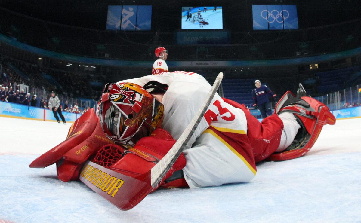 China's goaltender Jeremy Smith reacts after USA's Brian O'Neill scored a goal during the men's preliminary round group A match of the Beijing 2022 Winter Olympic Games ice hockey competition, at the National Indoor Stadium in Beijing on Feb. 10, 2022. (Bruce Bennett/POOL/AFP via Getty Images)