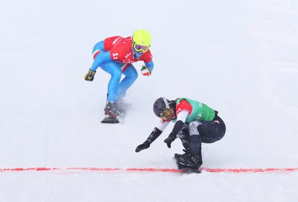 Lindsey Jacobellis of Team United States (R) and Michela Moioli of Team Italy cross the finish line during the snowboard mixed team cross big final on Day 8 of the Beijing 2022 Winter Olympics at Genting Snow Park, in Zhangjiakou, China, on Feb. 12, 2022. (Cameron Spencer/Getty Images)