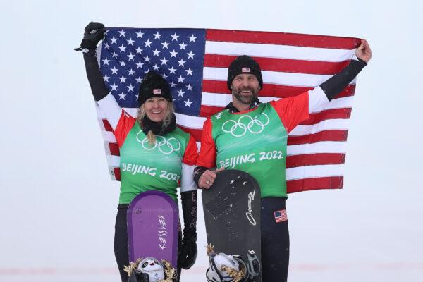 Gold medallists Lindsey Jacobellis and Nick Baumgartner of Team United States celebrate during the Mixed Team Snowboard Cross Finals flower ceremony on Day 8 of the Beijing 2022 Winter Olympics at Genting Snow Park, in Zhangjiakou, China, on Feb. 12, 2022. (Cameron Spencer/Getty Images)