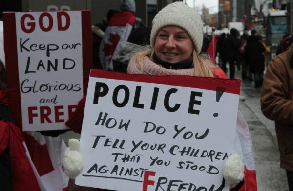 A protester with a sign in Ottawa, Canada, on Feb. 12, 2022. (Richard Moore/The Epoch Times)