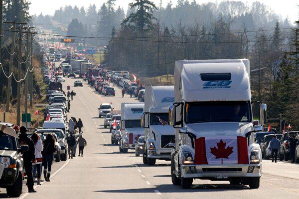Trucks and other vehicles drive on Highway 15 near the Pacific Highway Border Crossing, as part of a protest convoy demonstrating against COVID-19 mandates and restrictions, in Surrey, B.C., on Feb. 12, 2022. (Jason Redmon/AFP via Getty Images)