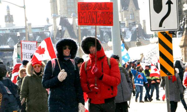 Protesters walk down Wellington St. in Ottawa on Feb. 12, 2022. (Noé Chartier/The Epoch Times)