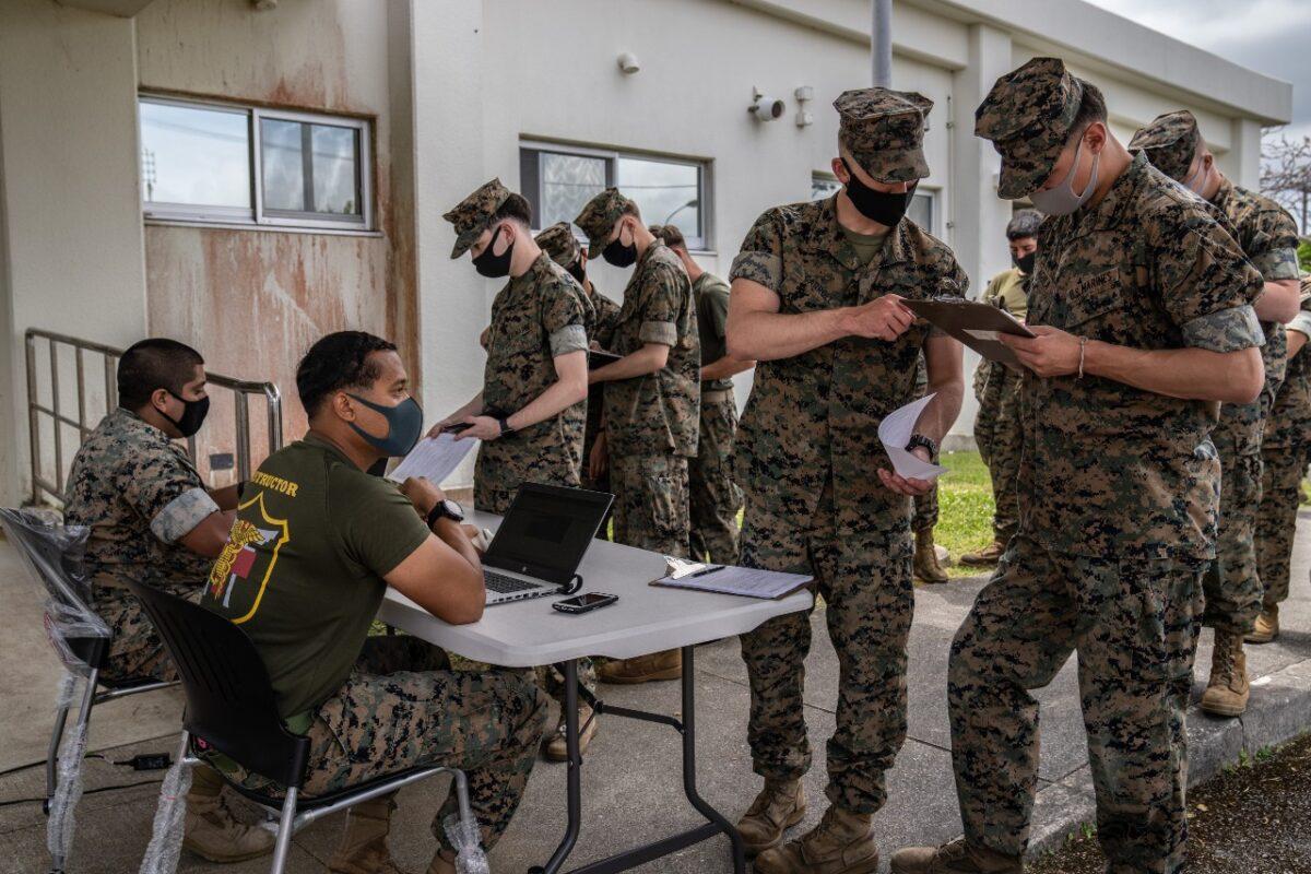United States Marines register their details as they queue to receive the Moderna coronavirus vaccine at Camp Hansen on April 28, 2021, in Kin, Japan. (Carl Court/Getty Images)