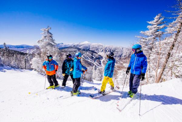 A group of friends take a moment to enjoy the view on a blue bird day. (Dennis Curran/Smugglers' Notch Resort)
