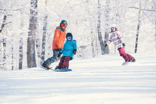A father and his children practice their snowboarding on one of the gentler trails. (Pat Kelley/Smugglers' Notch Resort)