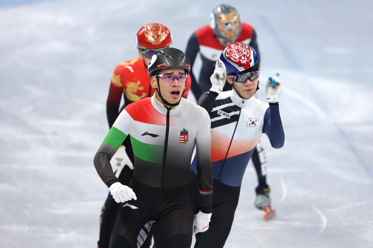 Shaolin Sandor Liu (L) of Team Hungary and Juneseo Lee (R) of Team South Korea react after skating during the Men's 1000 m Semifinals on day three of the Beijing 2022 Winter Olympic Games at Capital Indoor Stadium on February 07, 2022 in Beijing, China. (Lintao Zhang/Getty Images)