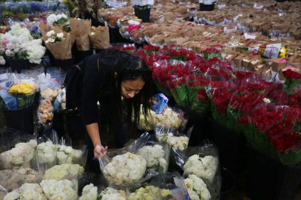 A customer selects flowers at the Bagala Bros flower stand at Sydney Markets ahead of Valentine’s Day in Sydney, Australia, on Feb. 12, 2022. (Lisa Maree Williams/Getty Images)