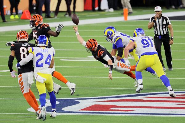 Joe Burrow #9 of the Cincinnati Bengals is sacked by Aaron Donald #99 of the Los Angeles Rams in the fourth quarter during Super Bowl LVI at SoFi Stadium, in Inglewood, Calif., on Feb. 13, 2022. (Andy Lyons/Getty Images)