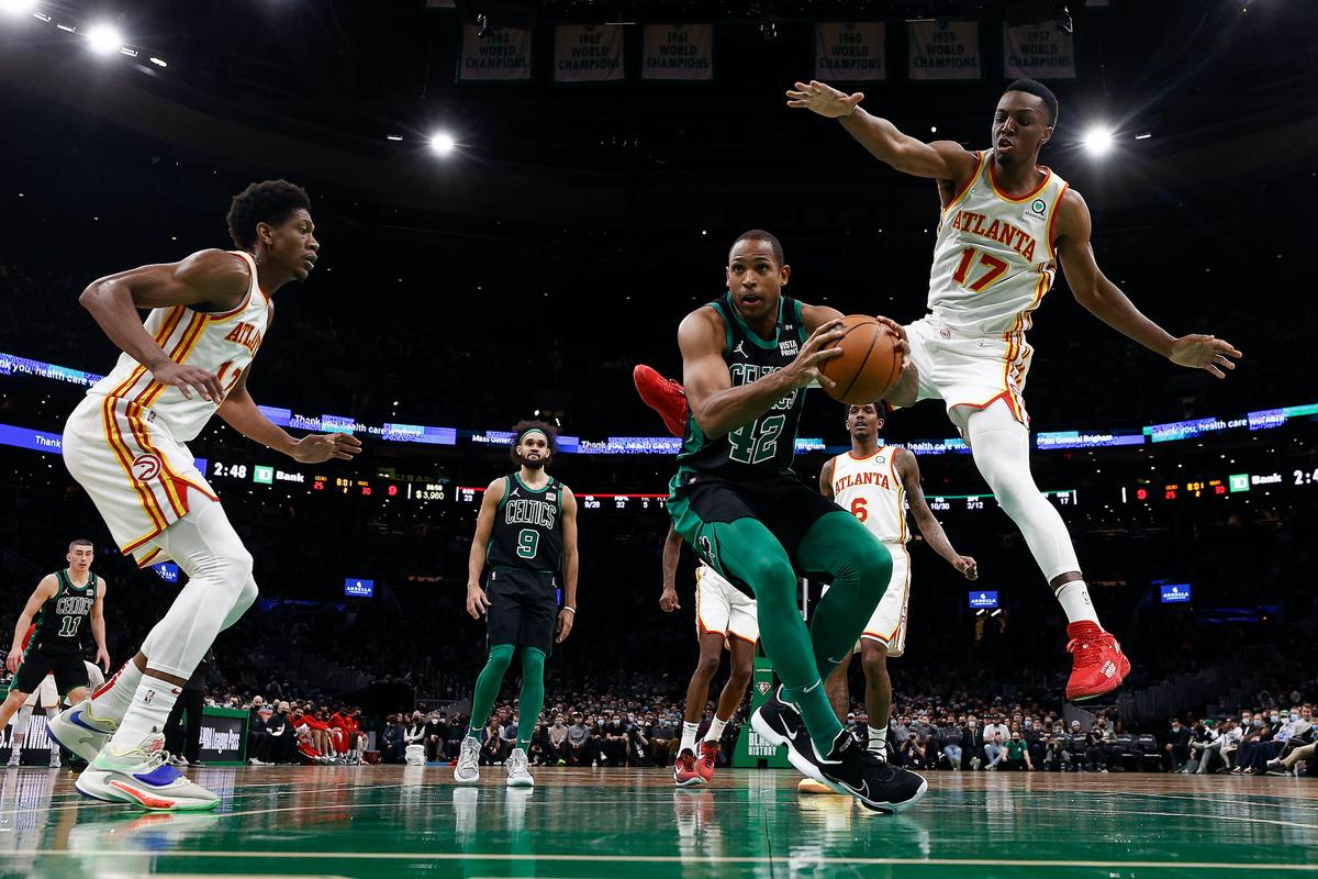 Boston Celtics' Al Horford looks for an opening around Atlanta Hawks' Onyeka Okongwu during the first quarter of an NBA basketball game in Boston, on Feb. 13, 2022. (Winslow Townson/AP Photo)