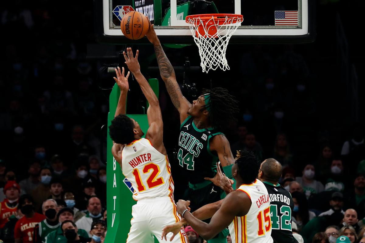 Boston Celtics' Robert Williams III blocks a shot by Atlanta Hawks' De'Andre Hunter during the first quarter of an NBA basketball game in Boston, on Feb. 13, 2022. (Winslow Townson/AP Photo)
