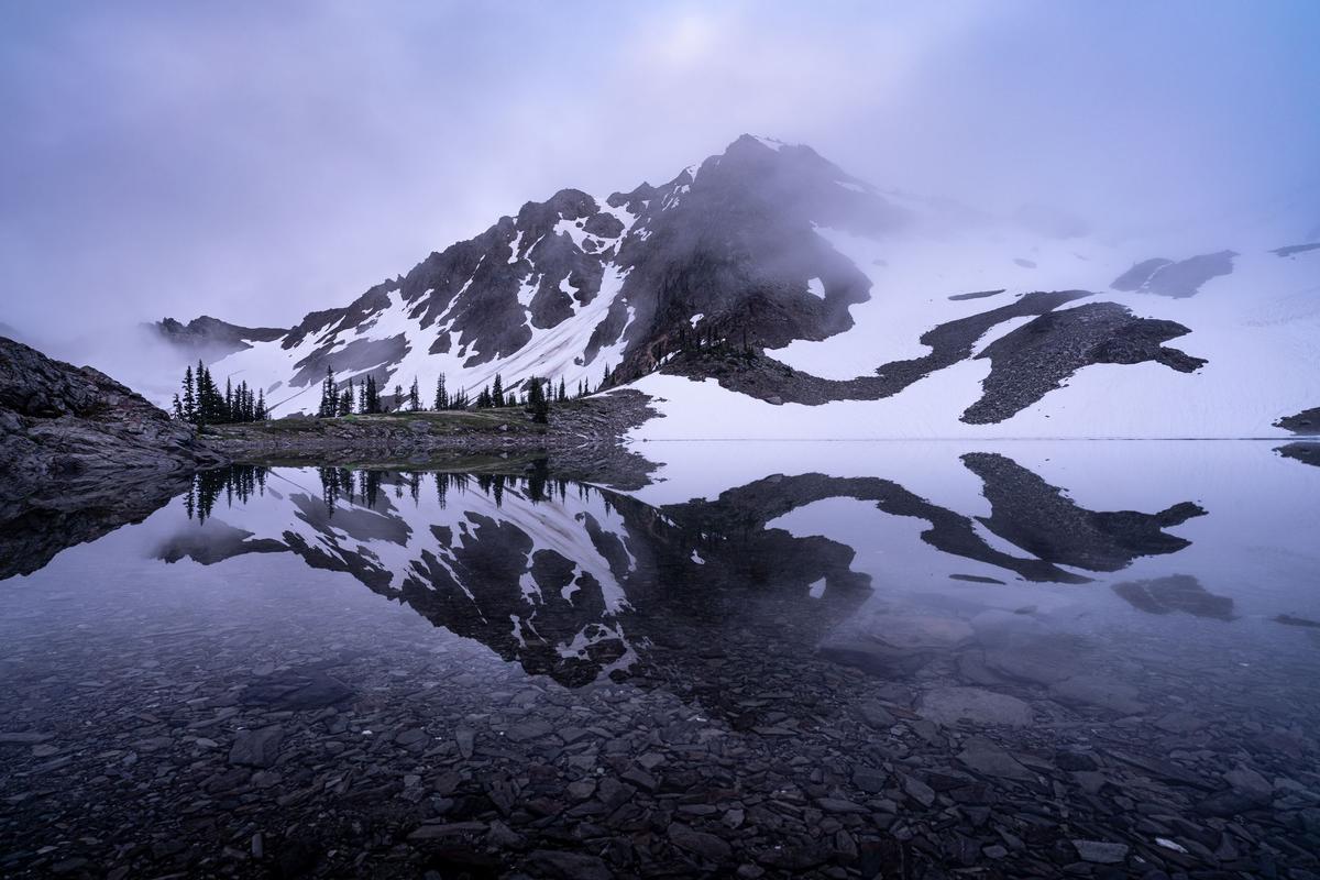 A glacier-fed alpine lake in the Olympic backcountry, with McCartney Peak behind it. (Courtesy of Nate Brown)