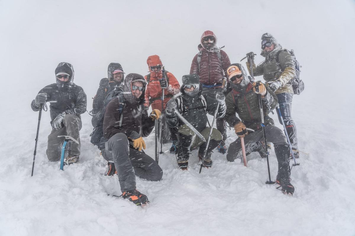 A group of veterans from Veterans Expeditions on the summit of Mount Saint Helens in a winter storm. (Courtesy of Nate Brown)