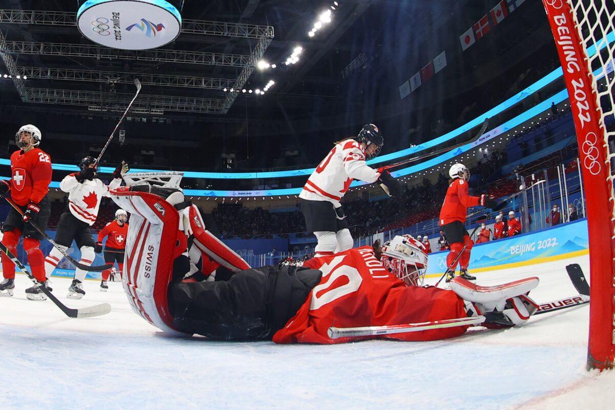 Canada's Blayre Turnbull (40) celebrates after scoring against Switzerland goalkeeper Andrea Braendli (20) during a women's semifinal hockey game at the 2022 Winter Olympics in Beijing, on Feb. 14, 2022. (Jonathan Ernst/Pool Photo via AP)