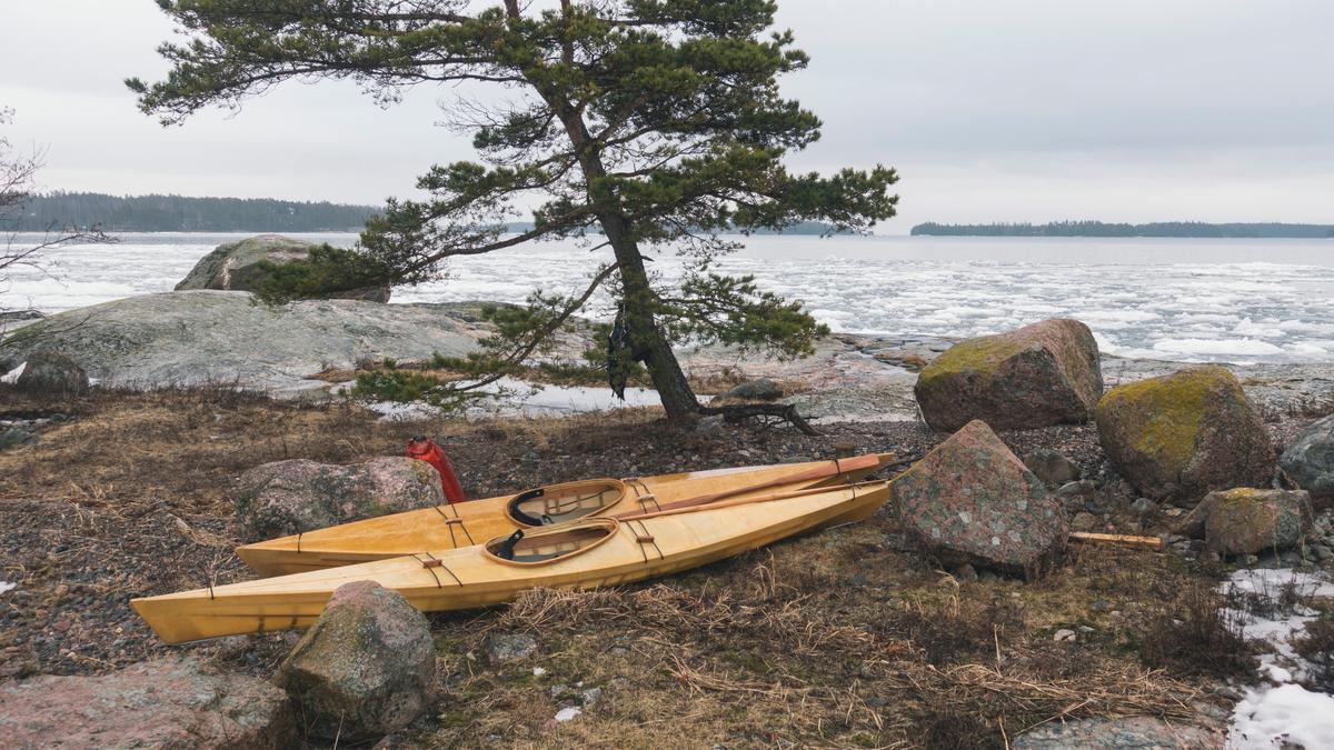 Kayaks made by one of Yuyan's students, Robin Falck, await the water at a site near Sipoo, Finland. Yuan's students can take several weeks or months to complete their first kayaks. (Kiliii Yuyan)