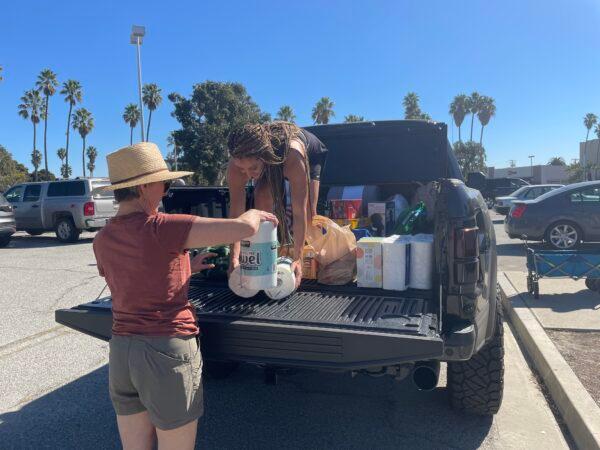 South Bay residents made donations at an anti-vaccine and mask mandate protest in Torrance, Calif., on Feb. 12. (Alice Sun/The Epoch Times)