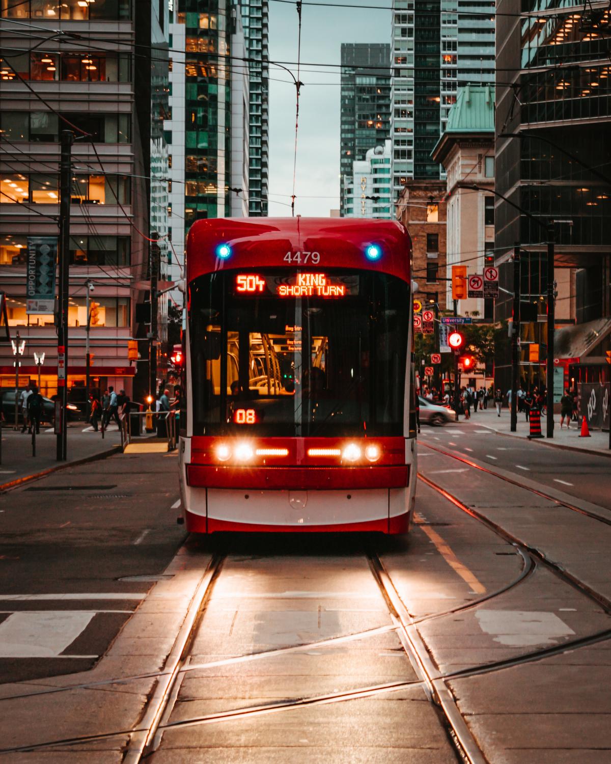 A street car travels through the streets of Toronto. (Aditya Chinchure/Unsplash)