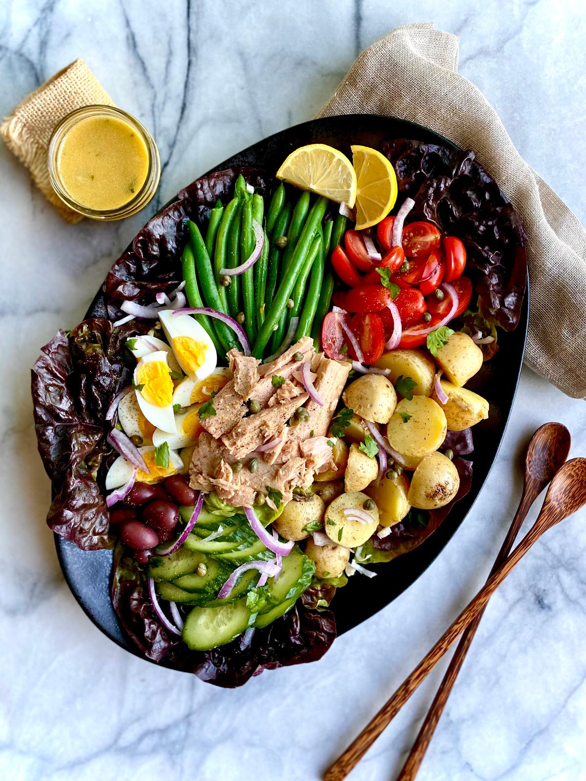 High-quality oil-packed tuna plays co-star to a medley of vegetables, hard-boiled eggs, and a smattering of salty, briny garnishes in this colorful salad. (Lynda Balslev for Tastefood)