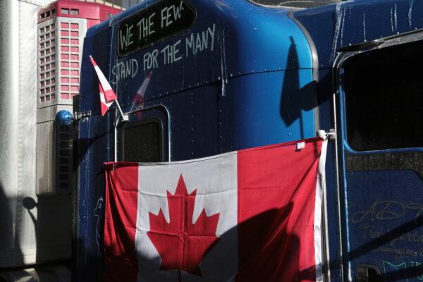  A message is written on a truck's cabin in the protest encampment in central Ottawa on Feb. 13, 2022. (Richard Moore/The Epoch Times)