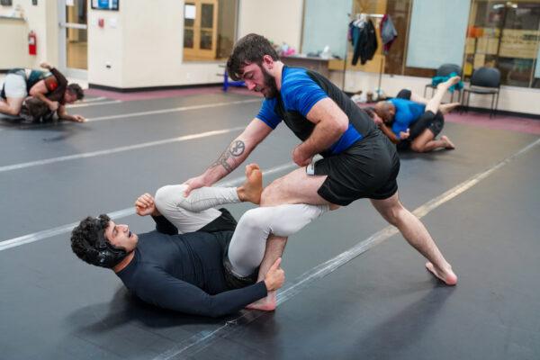 Champaign police officer Kenny Meyer (right) spars with an opponent at CU Jiu Jitsu gym in Urbana, Ill., on Feb. 10, 2022. (Cara Ding/The Epoch Times)