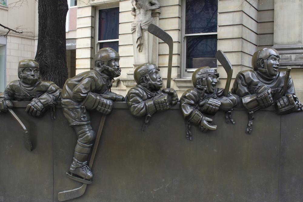 A bronze sculpture titled "Our Game" outside the Hockey Hall of Fame. (Alison Young/Shutterstock)