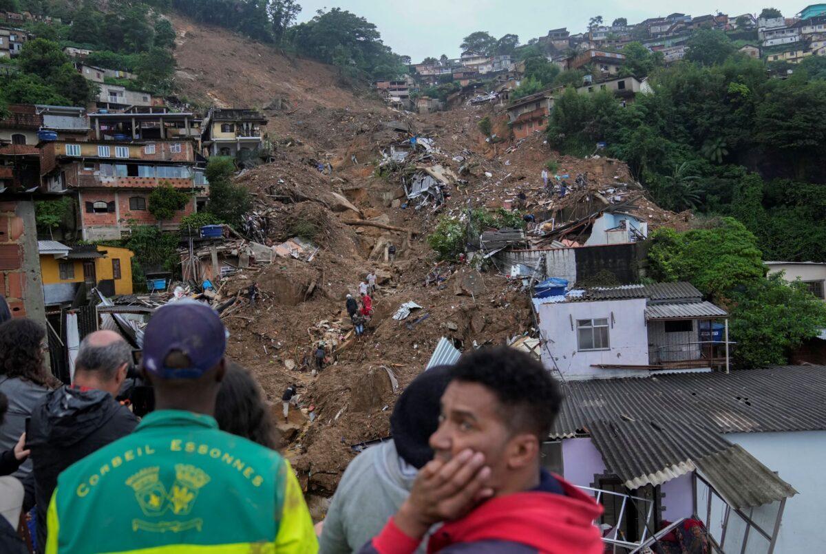 Rescue workers and residents look for victims in an area affected by landslides in Petropolis, Brazil, on Feb. 16, 2022. (Silvia Izquierdo/AP Photo)