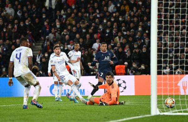 Kylian Mbappe of Paris Saint-Germain scores their team's first goal past Thibaut Courtois of Real Madrid during the UEFA Champions League round of 16 Leg One match between Paris Saint-Germain and Real Madrid at Parc des Princes stadium, in Paris, on Feb. 15, 2022. (Shaun Botterill/Getty Images)