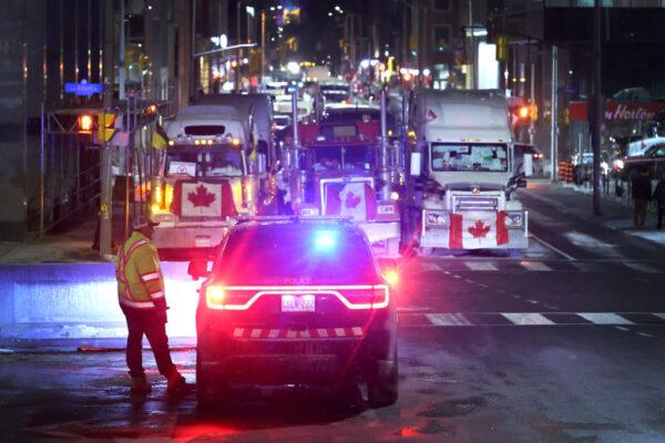 A police vehicle blocks a downtown street to prevent trucks from joining a blockade of truckers protesting vaccine mandates near the Parliament Buildings in Ottawa, Ontario, Canada, on Feb. 15, 2022. (Scott Olson/Getty Images)