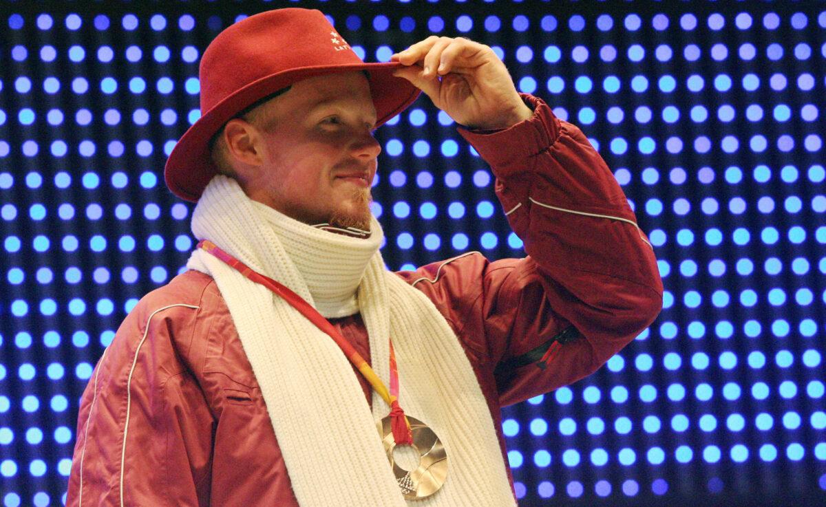 Bronze medalist Latvia’s Martins Rubenis celebrates during a 2006 Winter Olympics medal ceremony in Turin, Italy, on Feb. 13, 2006, a day after the singles luge final. (Thomas Coex/AFP via Getty Images)