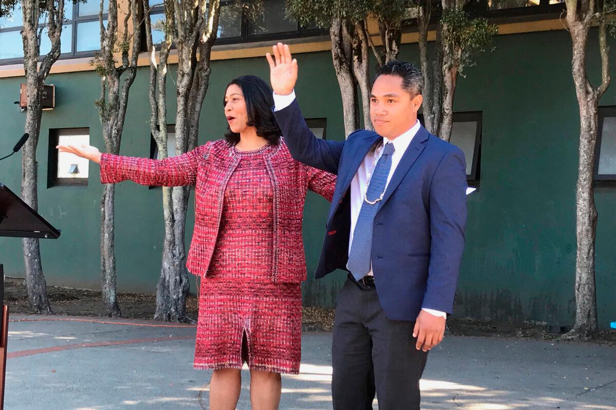 San Francisco Mayor London Breed, left, waves next to Faauuga Moliga, who she appointed to the school board, in San Francisco, Calif., in a file image. (Jill Tucker/San Francisco Chronicle via AP)