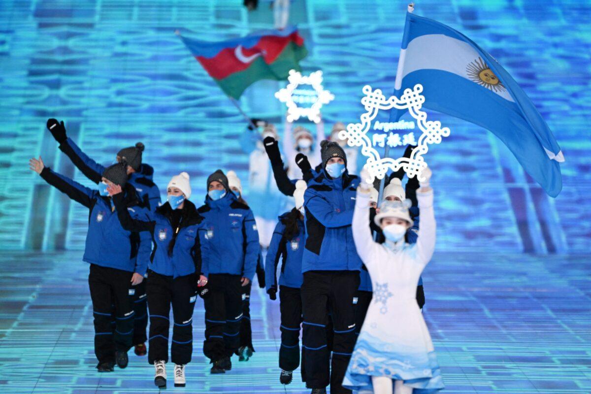 Argentina's flag bearers Francesca Baruzzi and Franco Dal Farra lead the delegation during the opening ceremony of the Beijing 2022 Winter Olympic Games, at the National Stadium, known as the Bird's Nest, in Beijing, on Feb. 4, 2022. (Manan Vatsyayana/AFP via Getty Images)