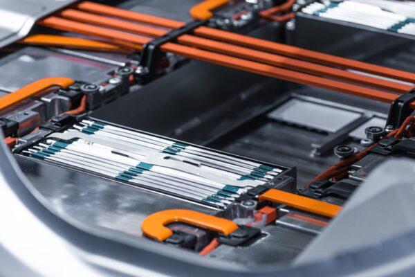 Electric vehicle lithium battery pack being constructed at a factory. (Sergii Chernov/Adobe Stock)