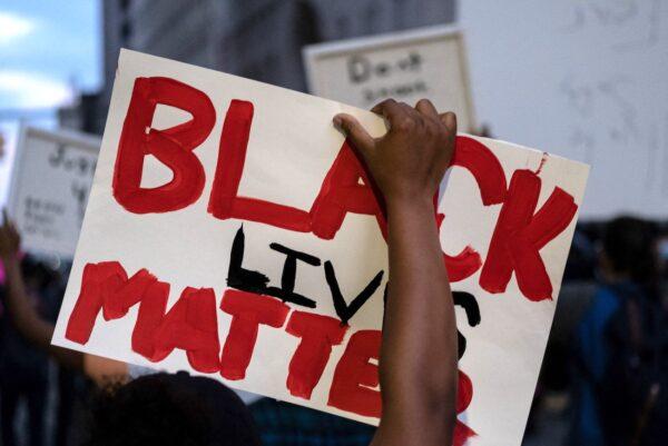 A protester holds a "Black Lives Matter" placard during a rally in Detroit, Mich., on May 29, 2020. (Seth Herald/AFP via Getty Images)