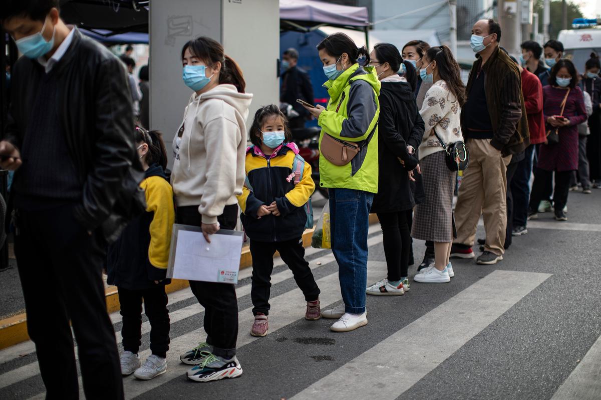Residents wear masks while lining up to receive COVID-19 vaccines at a vaccination site in Wuhan, China, on Nov. 18, 2021. (Getty Images)