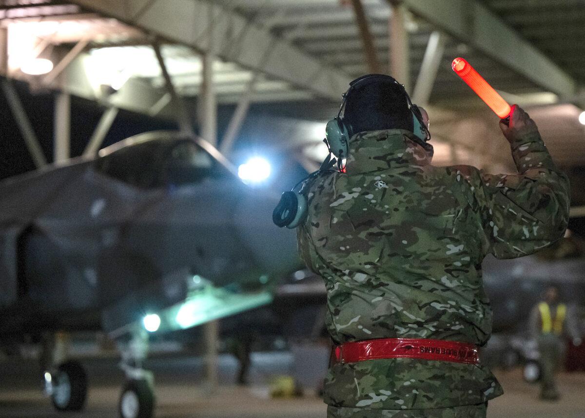 A crew chief from the 388th Fighter Wing marshalls an F-35A Lightning II as they launch for deployment to Spangdahlem Air Base, Germany, on Feb. 15, 2022. (Capt. Kip Sumner/U.S. Air Force)