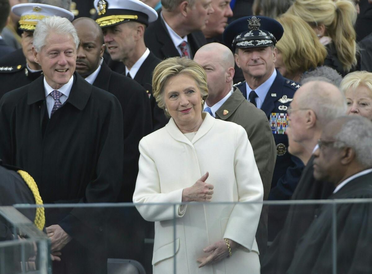 Former Democratic presidential candidate Hillary Clinton and former President Bill Clinton arrive on the platform at the U.S. Capitol in Washington, on Jan. 20, 2017. (Mandel Ngan/AFP/Getty Images)