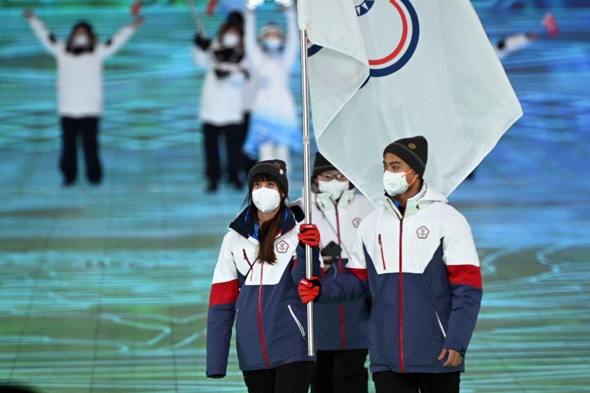 Taiwan's flag bearers Huang Yu-ting and Ho Ping-jui lead the delegation during the opening ceremony of the Beijing 2022 Winter Olympic Games, at the National Stadium, known as the Bird's Nest, in Beijing, on Feb. 4, 2022. (Manan Vatsyayana/AFP via Getty Images)