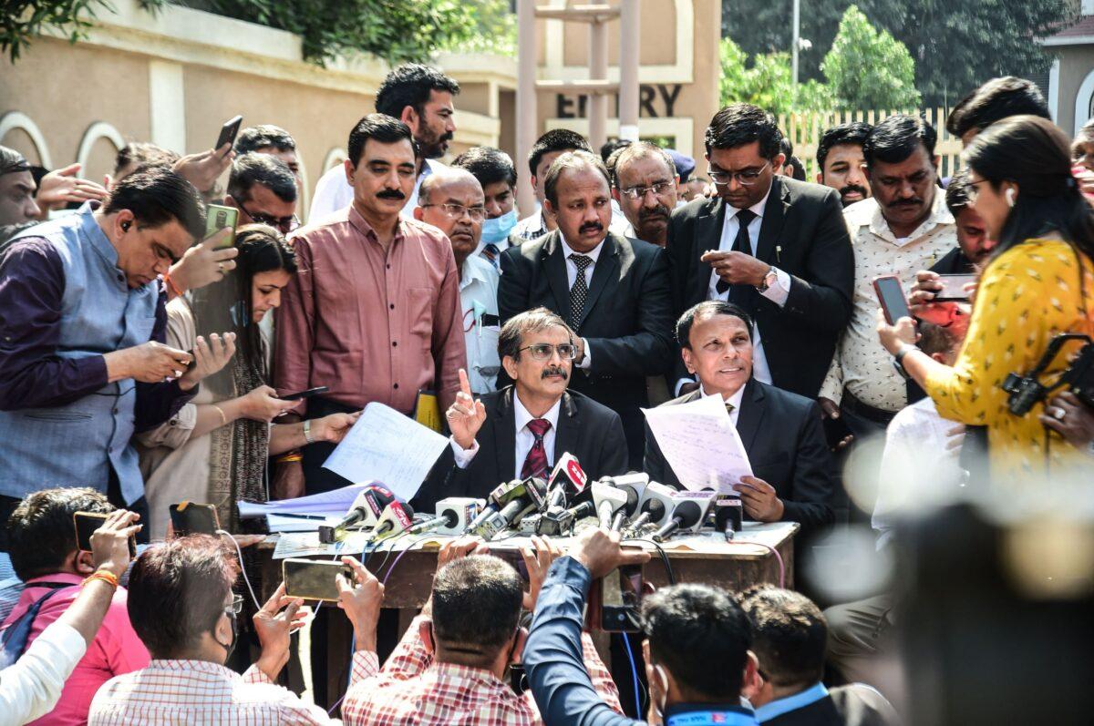 Public prosecutors A R Patel (Center L) and Sudhir Brahmbhatt (Center R) speak to the media outside the Sessions Court, after an Indian court sentenced 38 people to death in the city of Ahmedabad, India, on Feb. 18, 2022. (Sam Panthaky/AFP via Getty Images)