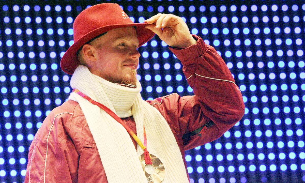 Bronze medalist Martins Rubenis of Latvia celebrates during a 2006 Winter Olympics medal ceremony in Turin, Italy, on Feb. 13, 2006. (Thomas Coex/AFP via Getty Images)
