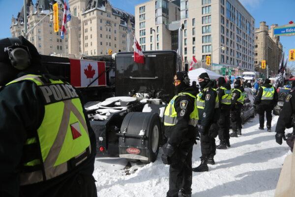 A police line forms near trucks in Wellington St in Ottawa on Feb. 18, 2022.