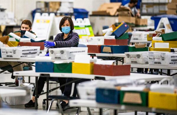 Los Angeles Registrars Office personnel process mail-in voting ballots in Pomona, Calif., on Aug. 31, 2021. (John Fredricks/The Epoch Times)