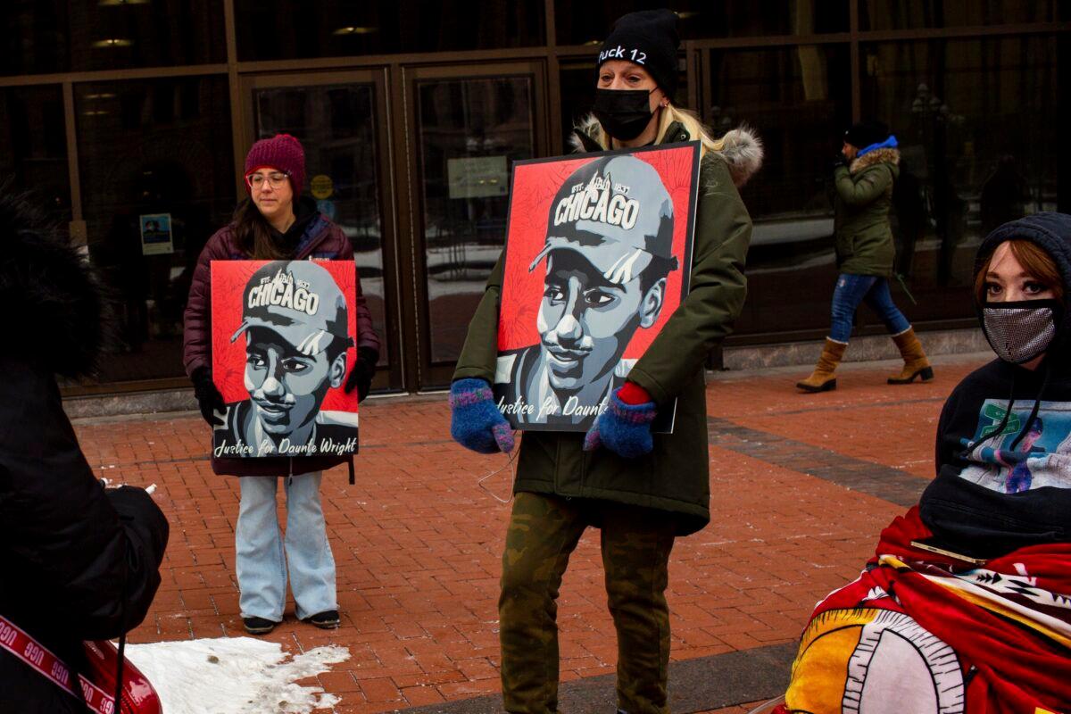 Demonstrators hold Justice for Daunte Wright signs in Minneapolis, Minn., on Feb. 18, 2022. (Nicole Neri/AP Photo)